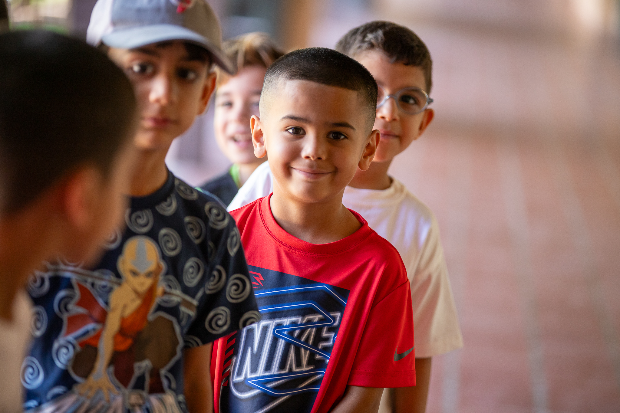 Students smile as they stand in line on the first day