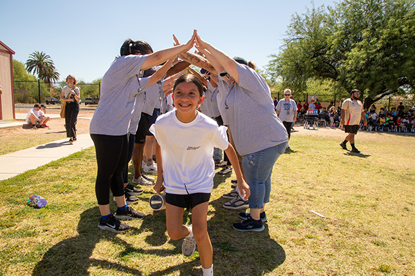 A girl excitedly runs through the spirit tunnel
