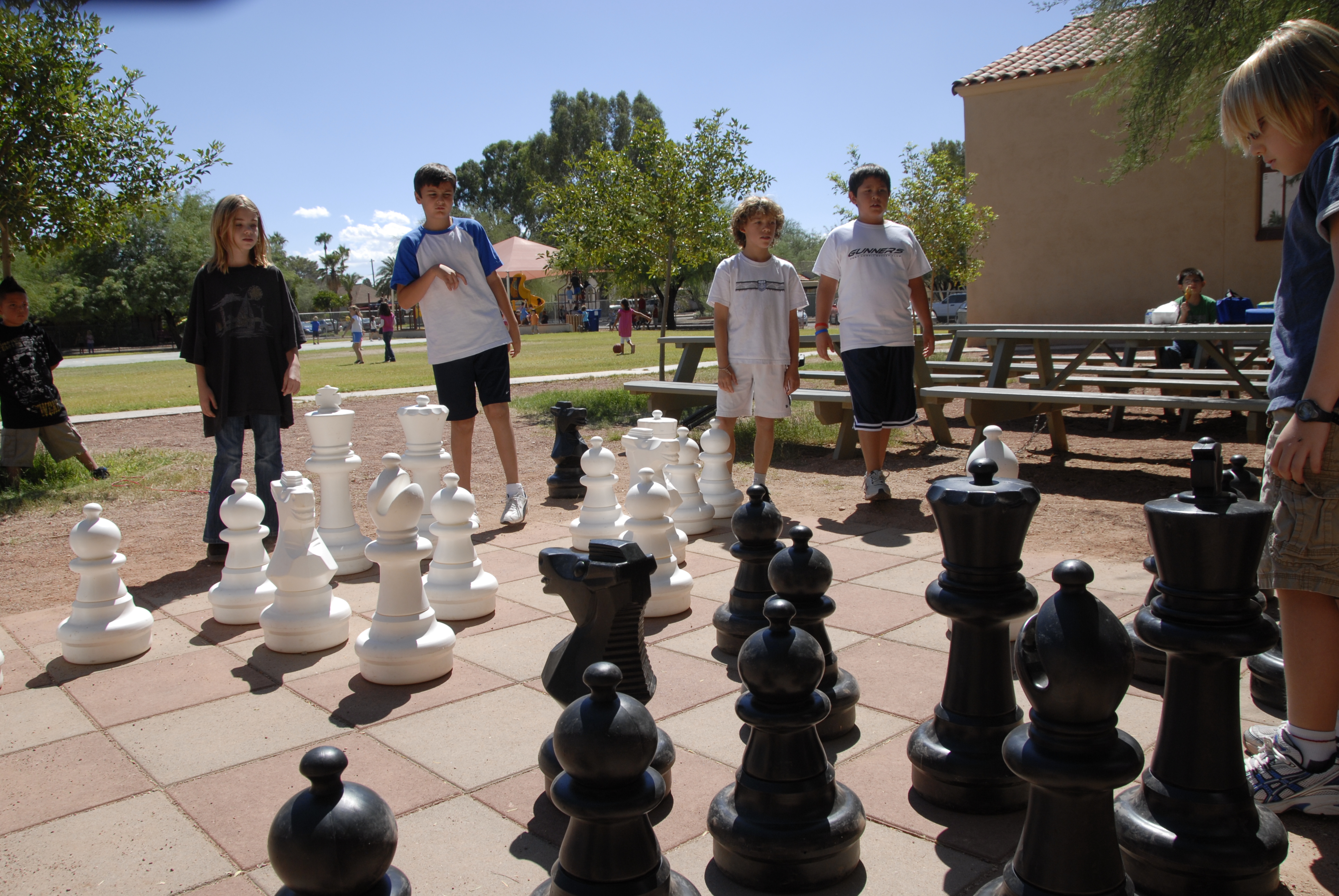 Students play chess on a life-size chess board