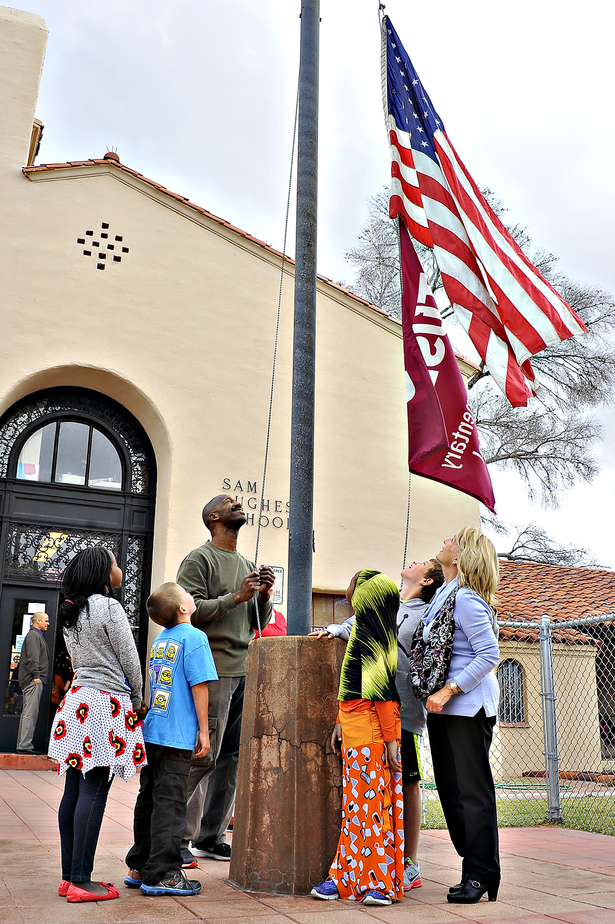 Students look up at the flag as its being raised